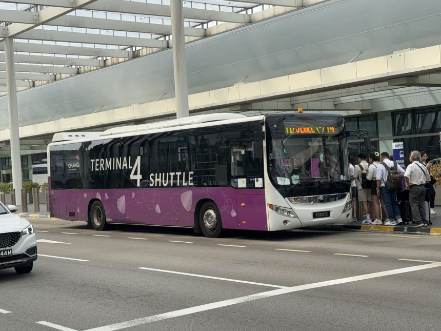 an airport shuttle bus outside a terminal