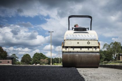 workers resurfacing a road with fresh asphalt